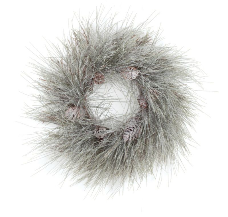 This artificial long needle pine wreath is covered in snow and makes a 